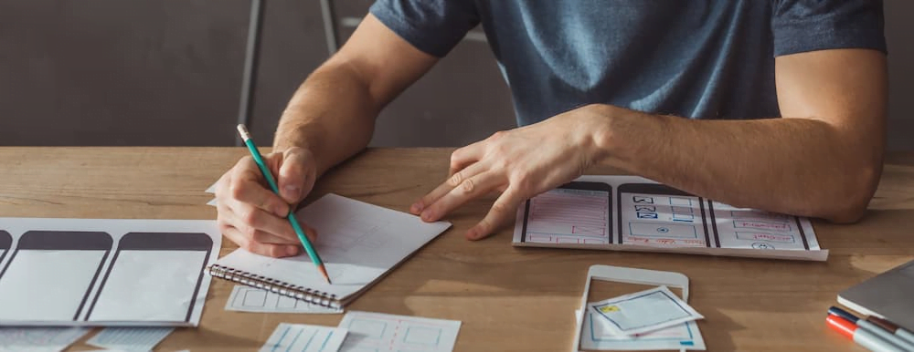 Man drawing user friendly wireframes