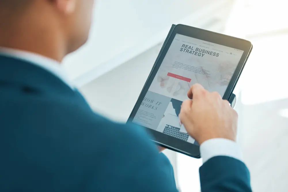 Business man hand and tablet screen and website