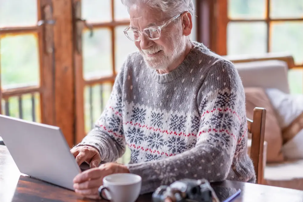 Smiling white haired senior man in winter sweater